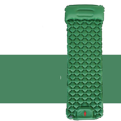 Camper resting on an inflatable sleeping pad outdoors